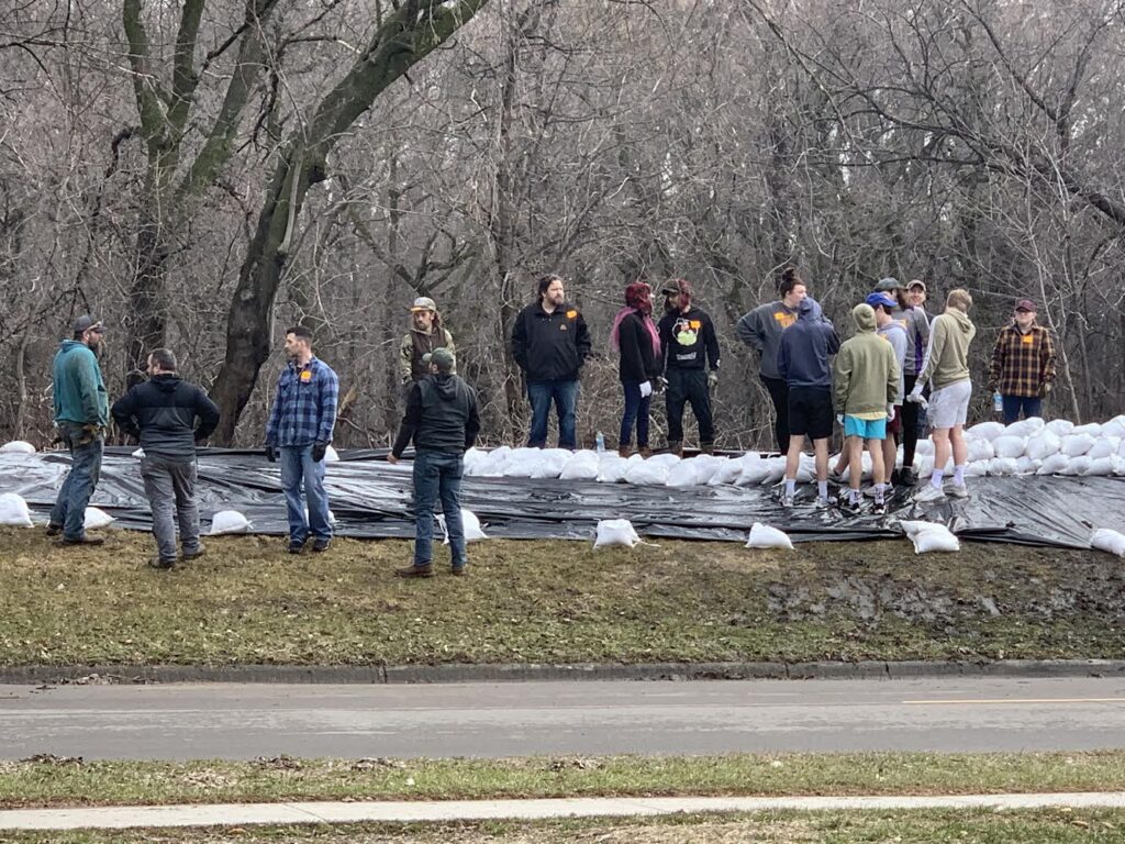 THERE IS AN URGENT NEED FOR SANDBAGGERS ON 3RD AVE
