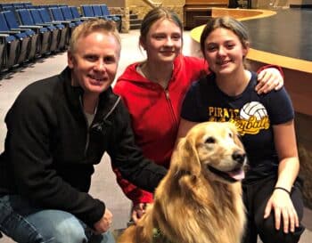 Ben Rudrud with two students and a dog