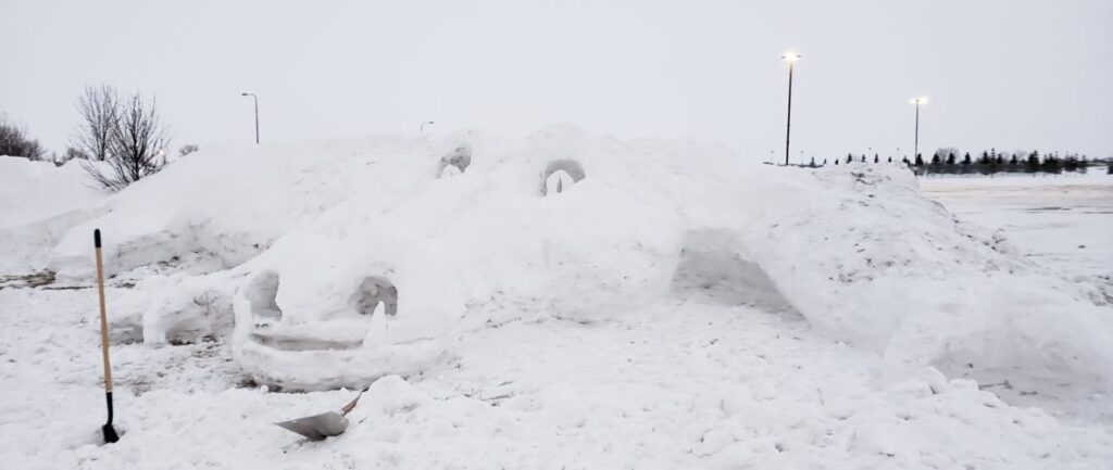 LOCAL ARTISTS CREATE SNOW SCULPTURE AT HIGH SCHOOL