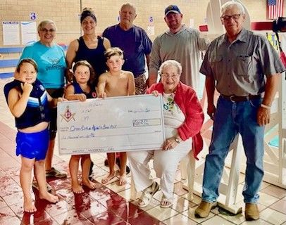 Fin and Fit Crookston receives program donation from Crookston Masonic Lodge, provides updates on pool mural and National Swimming Pool Day