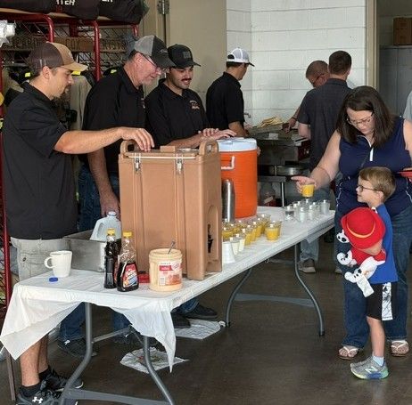 Crookston firefighters serve up breakfast during Ox Cart Days